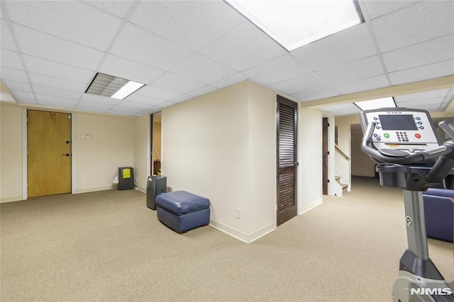 basement with a paneled ceiling and carpet floors