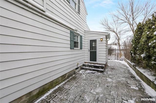 snow covered property featuring a patio area