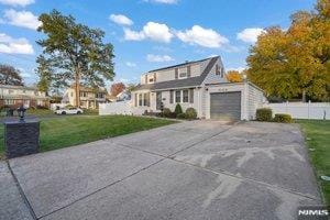 view of front of home featuring a garage and a front yard