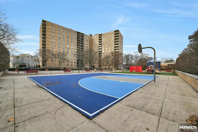 view of sport court featuring a playground