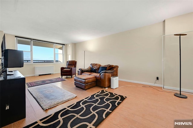 living room featuring radiator and light hardwood / wood-style flooring