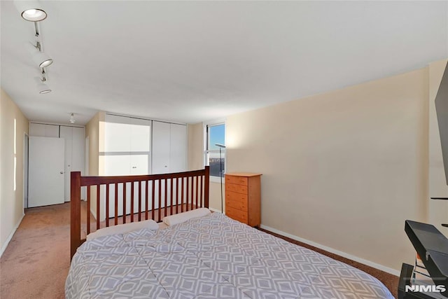 bedroom with carpet and track lighting