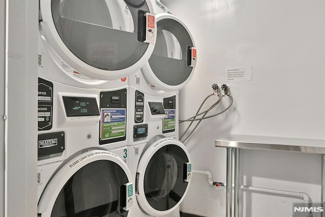 laundry room with stacked washer and dryer