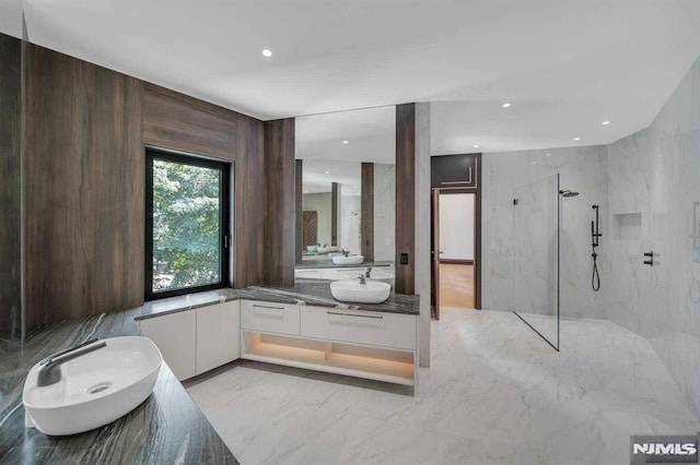 bathroom with vanity and tiled shower