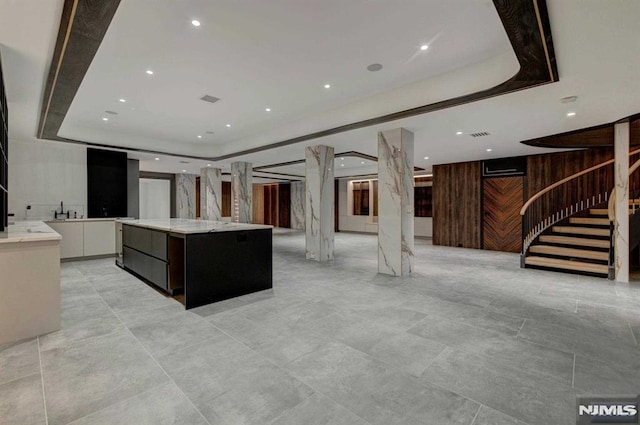 kitchen featuring a large island, white cabinetry, and a tray ceiling