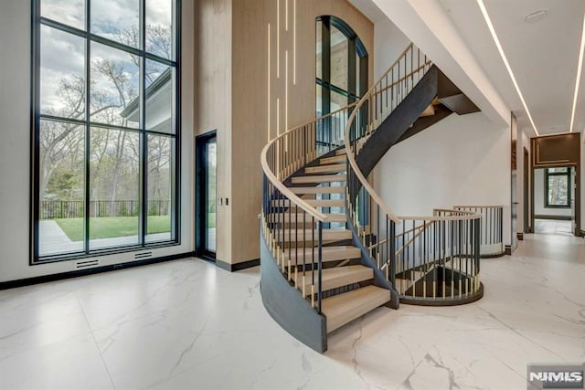 staircase with a high ceiling