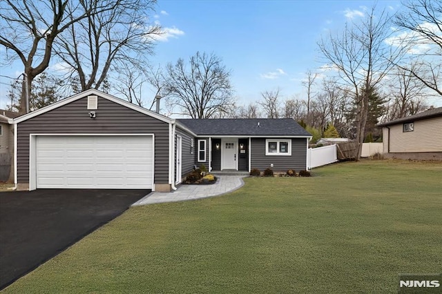 view of front of home with a front lawn and a garage