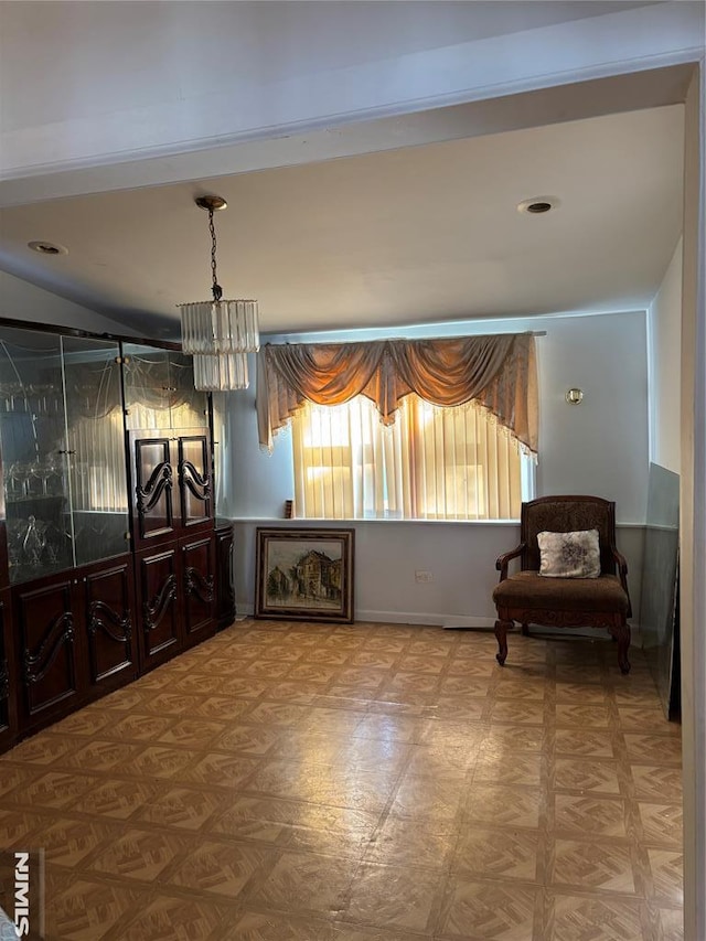 sitting room featuring light parquet floors and a chandelier