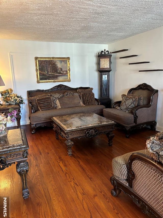 living room featuring a textured ceiling and hardwood / wood-style flooring