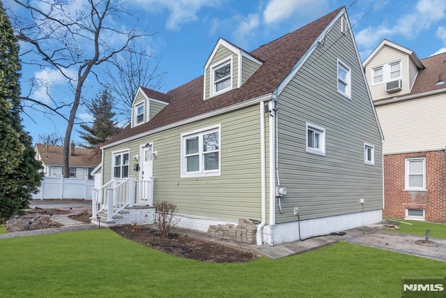 view of front facade with a front lawn and cooling unit