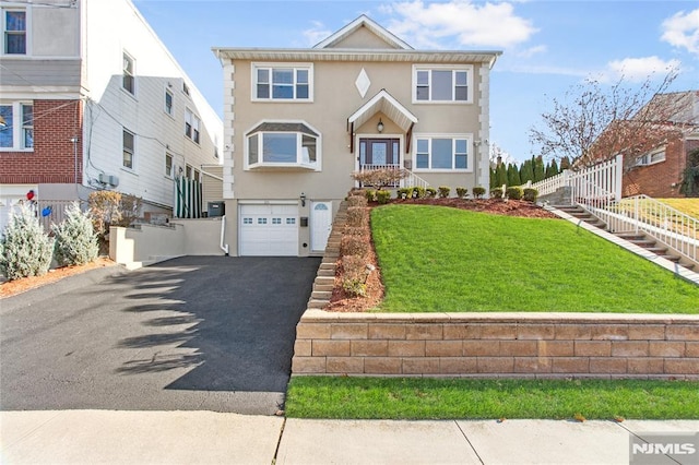 view of front of property with a garage and a front lawn