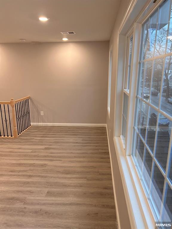 unfurnished room with wood-type flooring