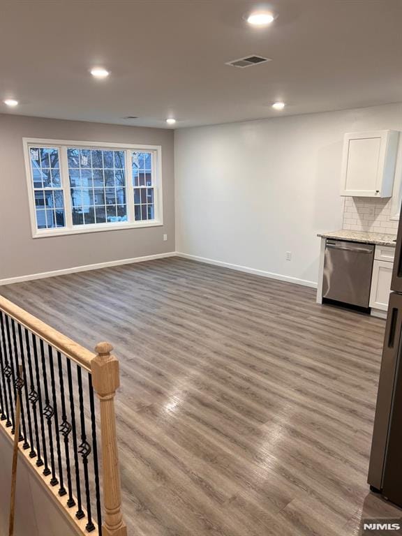 unfurnished living room with dark hardwood / wood-style flooring