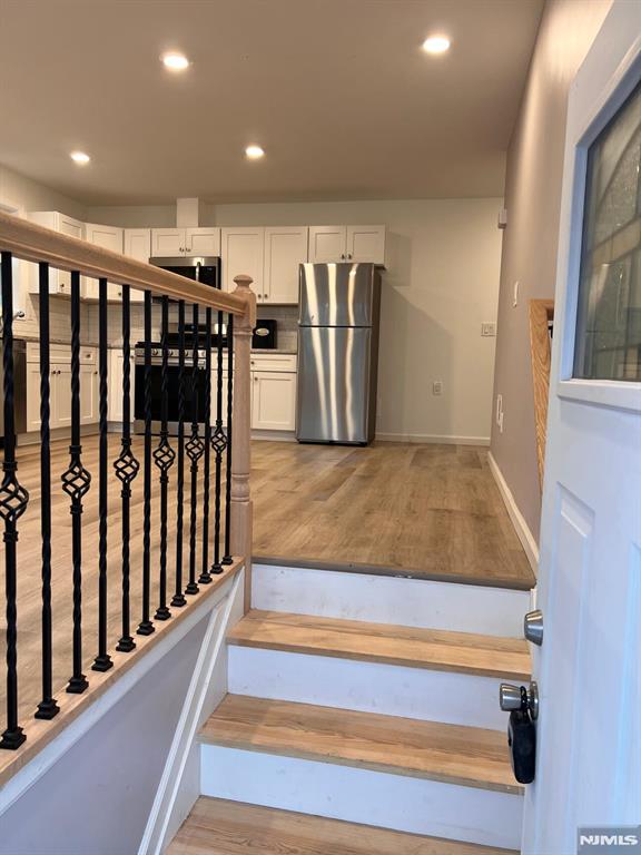 stairs with hardwood / wood-style flooring