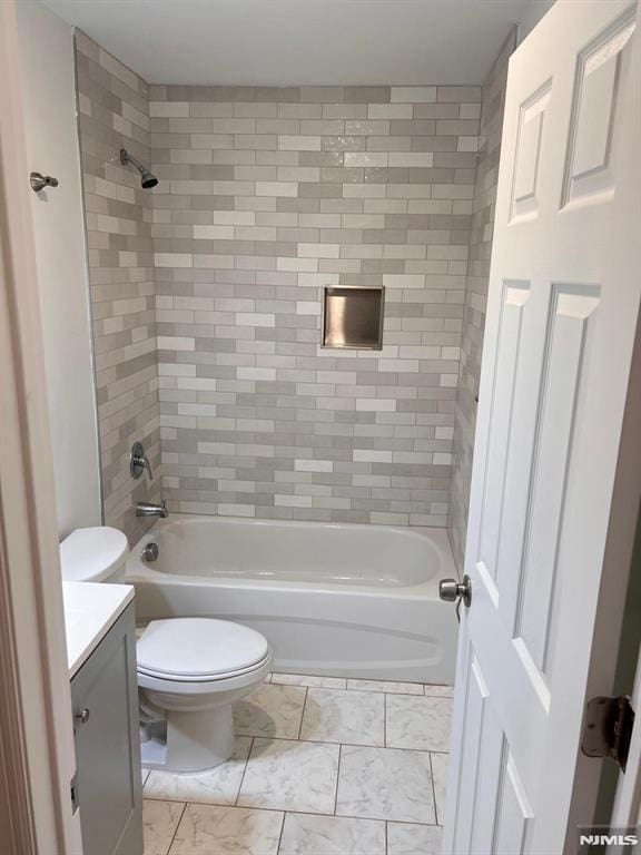 full bathroom featuring vanity, toilet, and tiled shower / bath combo