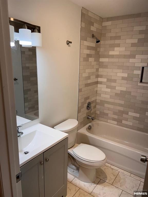 full bathroom with tile patterned flooring, vanity, toilet, and tiled shower / bath combo