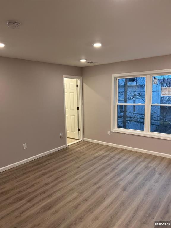 spare room featuring hardwood / wood-style floors