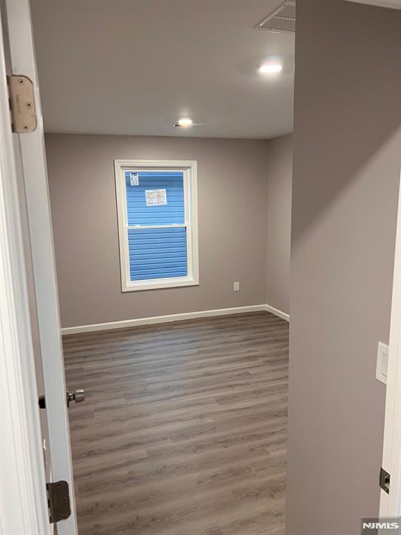 empty room with dark wood-type flooring