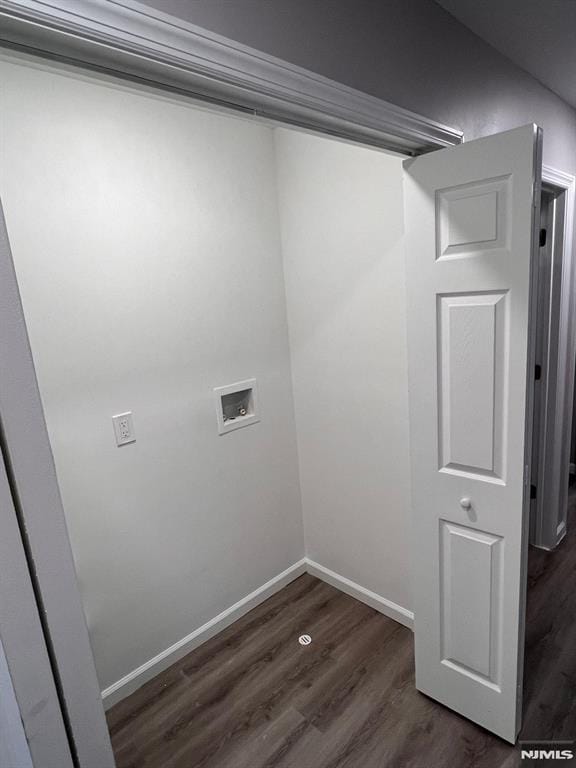 washroom with dark hardwood / wood-style flooring and hookup for a washing machine