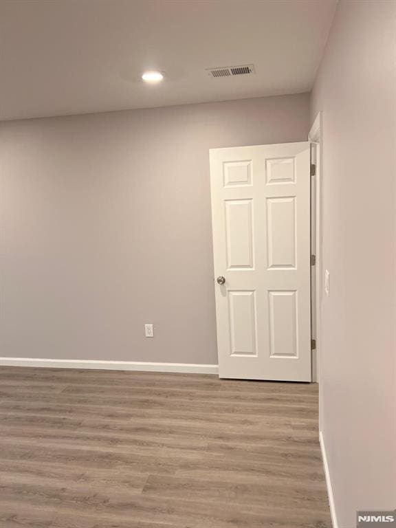 empty room with light hardwood / wood-style flooring