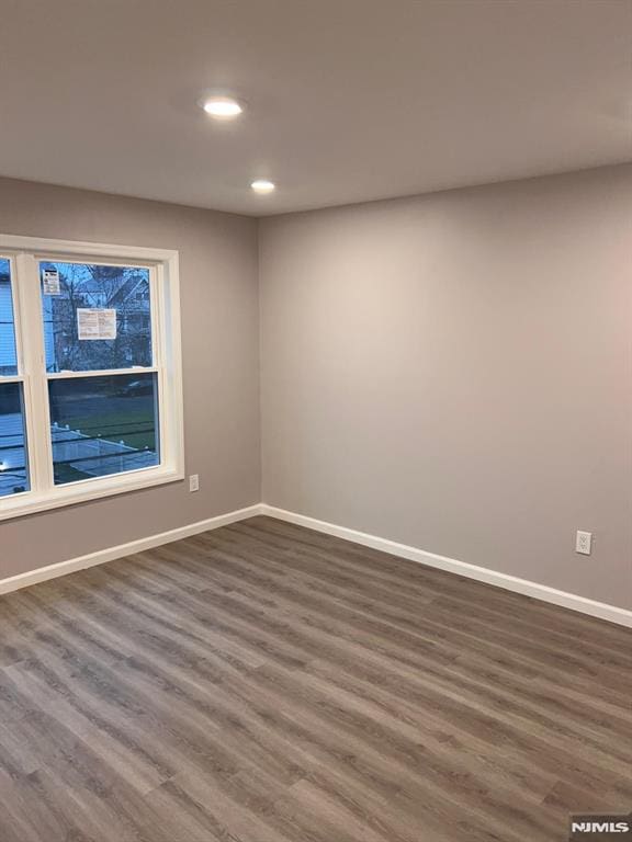 spare room with dark hardwood / wood-style floors