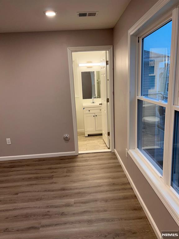 hallway featuring hardwood / wood-style flooring