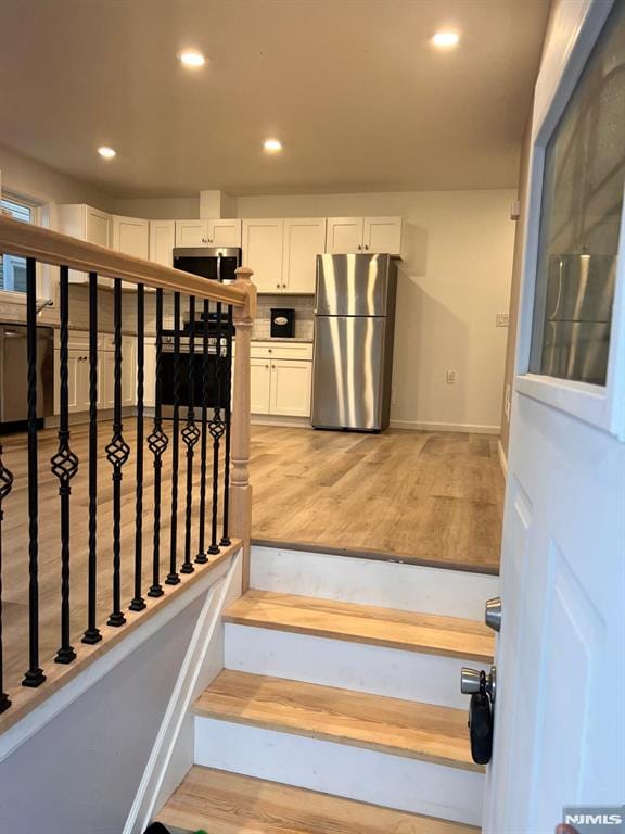 stairway with hardwood / wood-style flooring