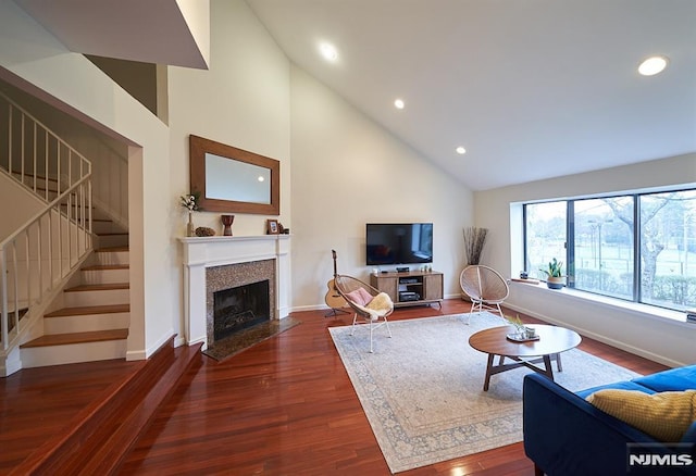 living room featuring dark hardwood / wood-style flooring and high vaulted ceiling