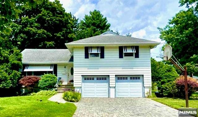 view of front of house featuring a garage and a front lawn