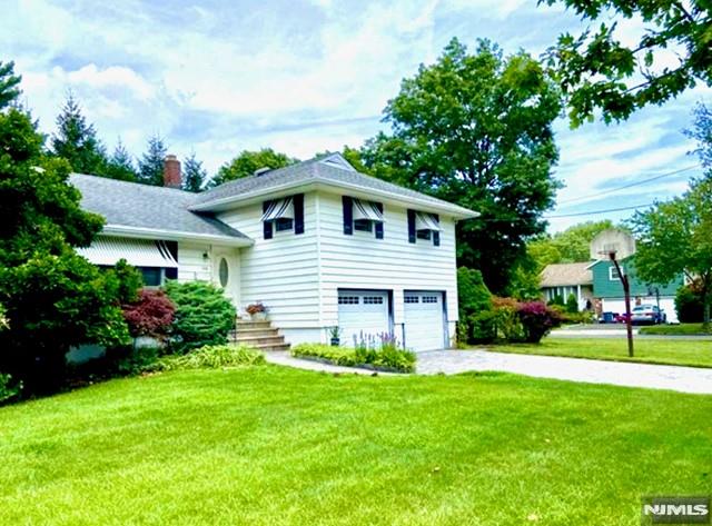 view of front facade with a front yard and a garage