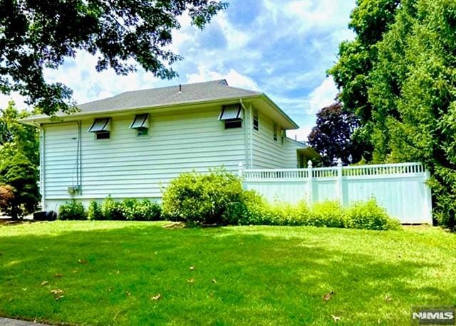 view of side of home featuring a lawn