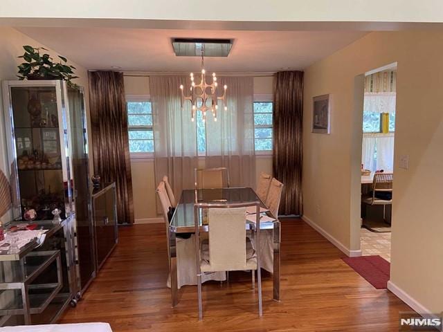 dining space with a chandelier and light wood-type flooring