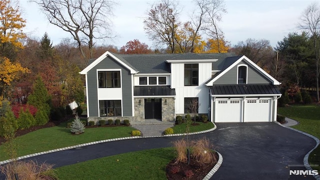 view of front of house featuring a front yard and a garage