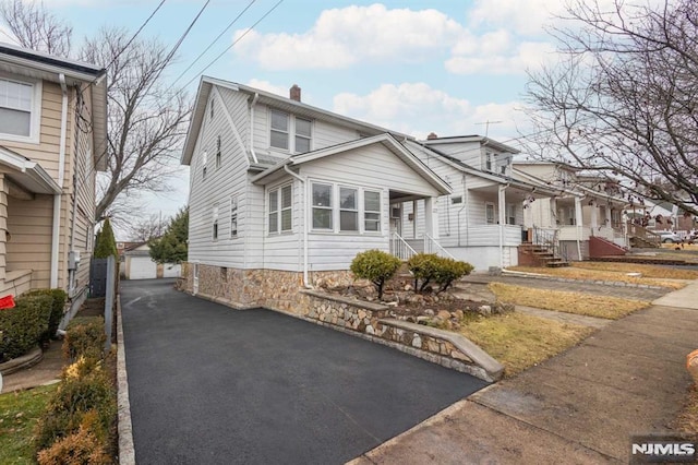 view of front of house featuring a garage and an outdoor structure