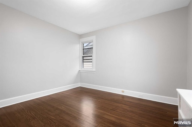 empty room featuring dark hardwood / wood-style floors