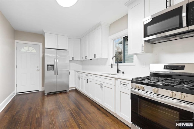 kitchen featuring white cabinets, dark hardwood / wood-style flooring, stainless steel appliances, and sink