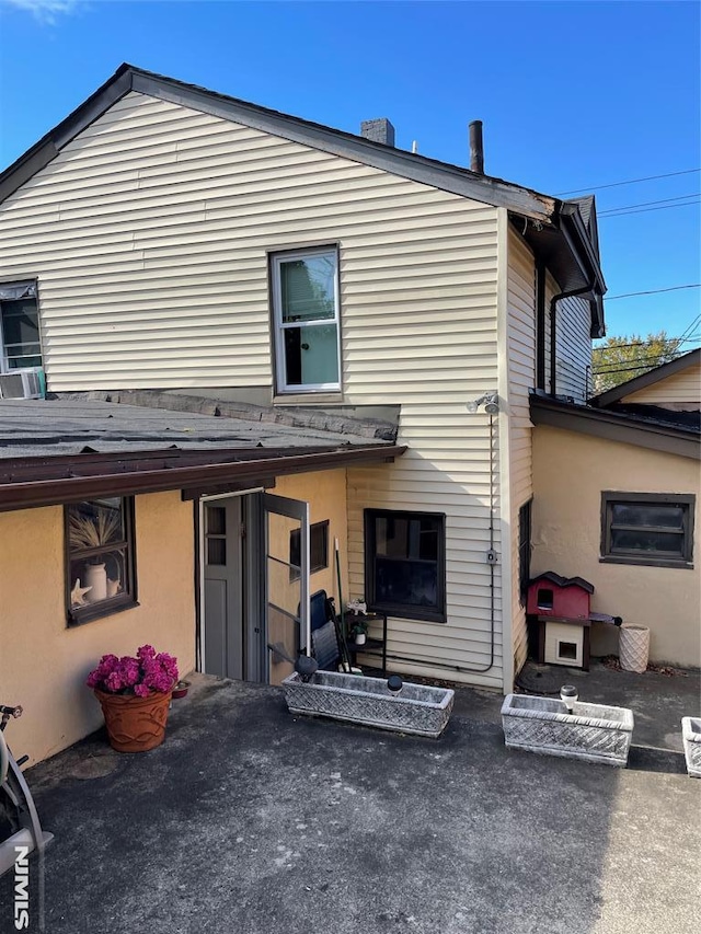 back of house with cooling unit and a patio