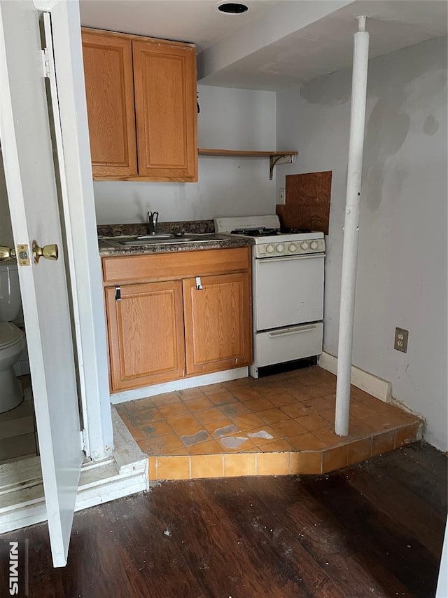 kitchen with white range oven, sink, and light hardwood / wood-style flooring