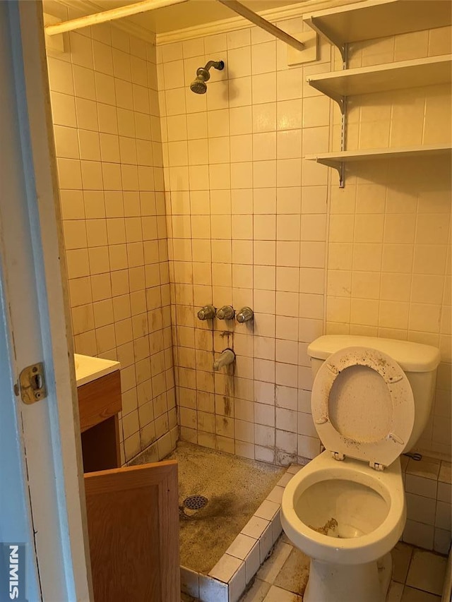 bathroom with tile patterned floors, toilet, a shower, and tile walls