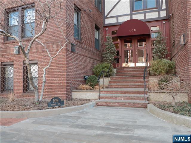 doorway to property featuring brick siding