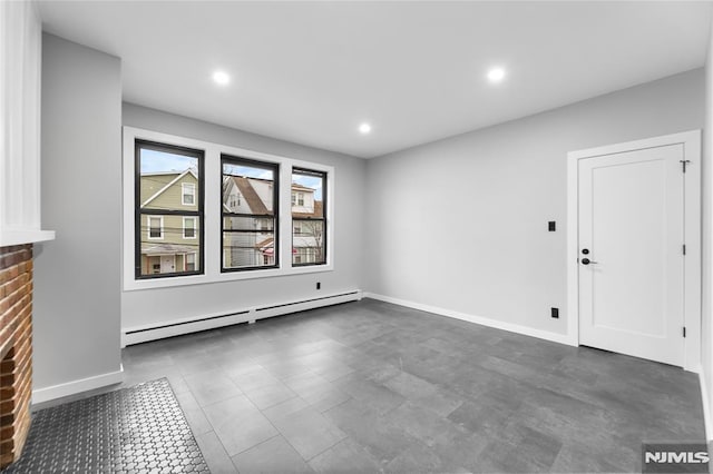 unfurnished living room featuring a fireplace and baseboard heating