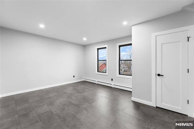 spare room featuring a baseboard heating unit