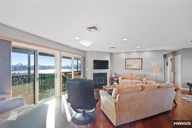 living room featuring hardwood / wood-style floors and a water view