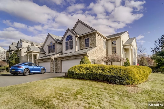 view of front of property with a front lawn and a garage