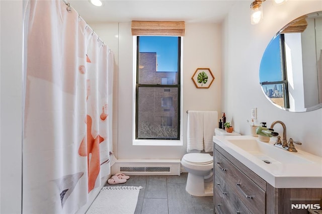 bathroom featuring toilet, a shower with shower curtain, and vanity