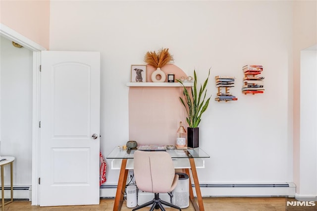 office space with a baseboard heating unit