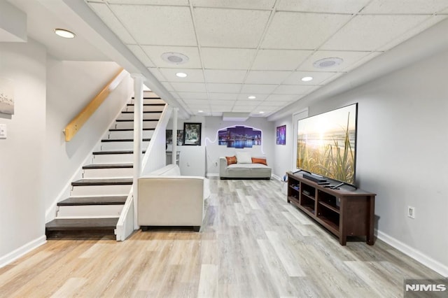 interior space featuring light wood-type flooring and a drop ceiling