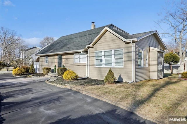 view of side of home with a lawn