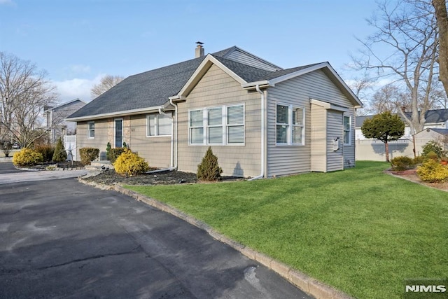 view of home's exterior with a lawn