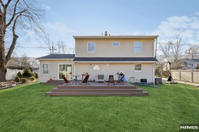 rear view of property featuring a wooden deck, cooling unit, and a yard